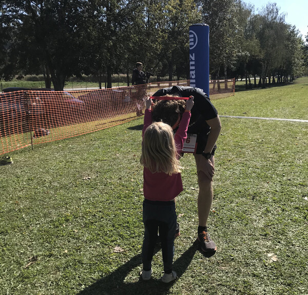 My daughter Vera handing me my medal