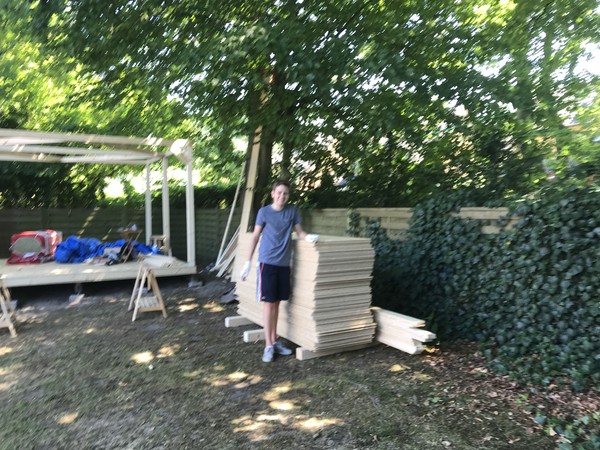 Okay I admit I had some help. David, the neighbor’s son, bravely carried these 88 sheets of OSB from my car into the garden with me. It took literal hours and we lost liters of sweat. Thanks, David!