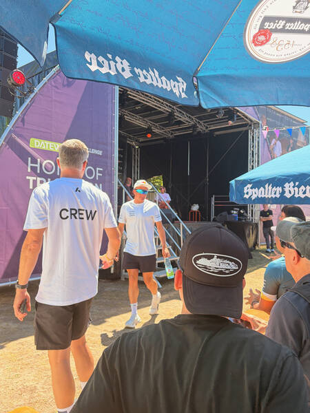 Olympic gold medalist and World Champion Kristian Blummenfelt casually walking by the live podcast stage after having spontaneously joined talks for a few minutes