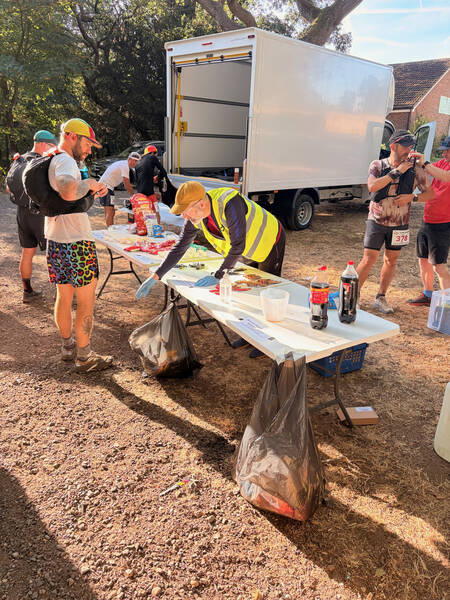 A few folks refueling at the first little aid station, located in Puttenham