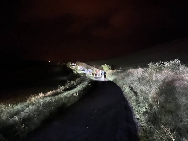 Leading up the hills in the crowds illuminating the roads with their headlamps