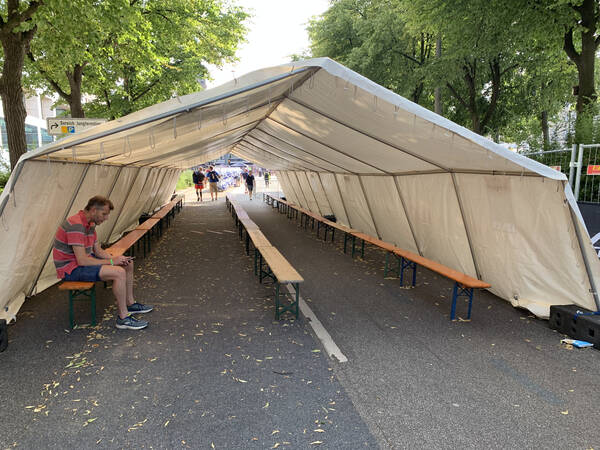 Lonely dude sitting in the transition zone changing tent.